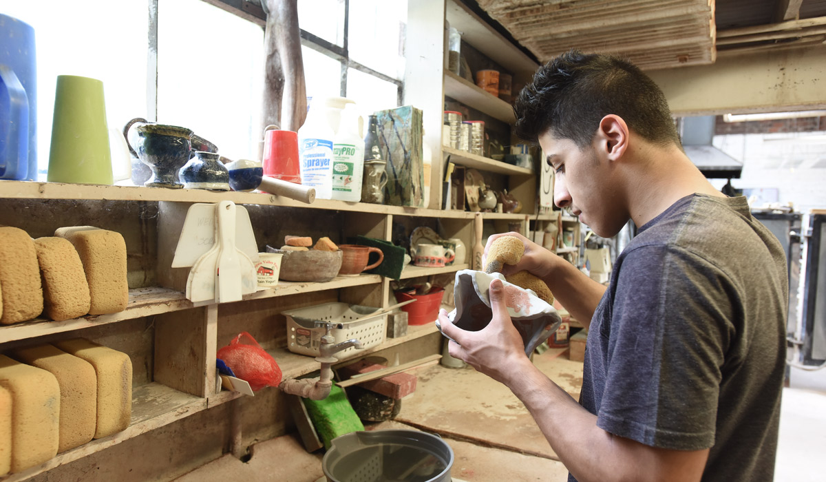 Sculpture student at work in ceramics studio