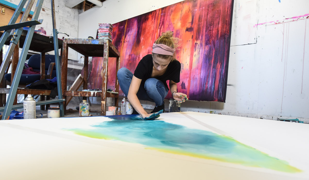 art student painting in studio